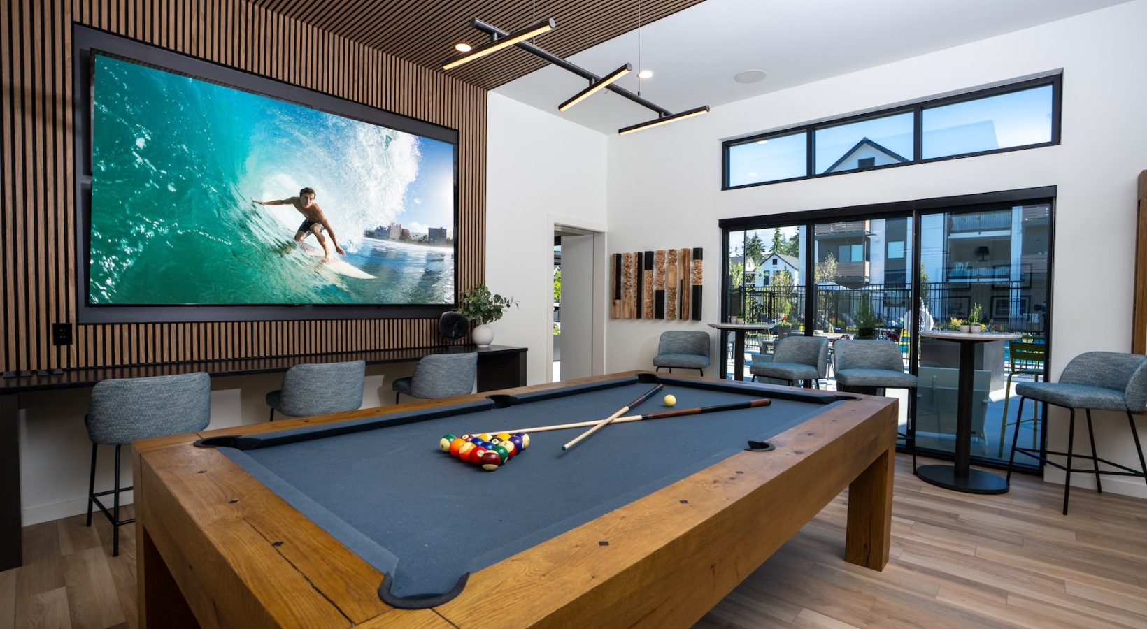 a clubroom with a pool table and a tv