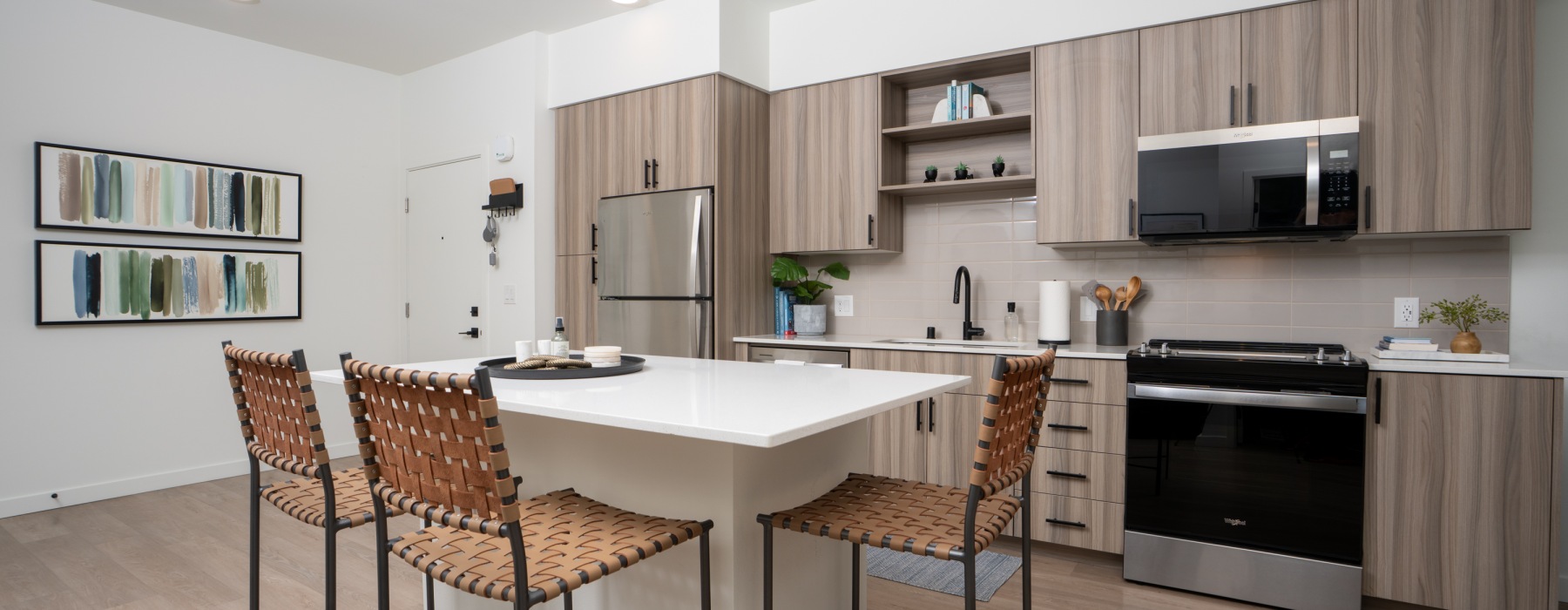 Apartment kitchen with island, cabinets, and appliances