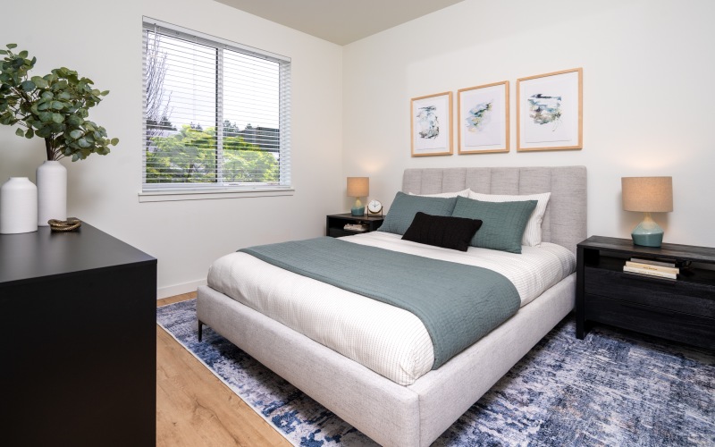 bedroom with bed, dresser, and nighstand